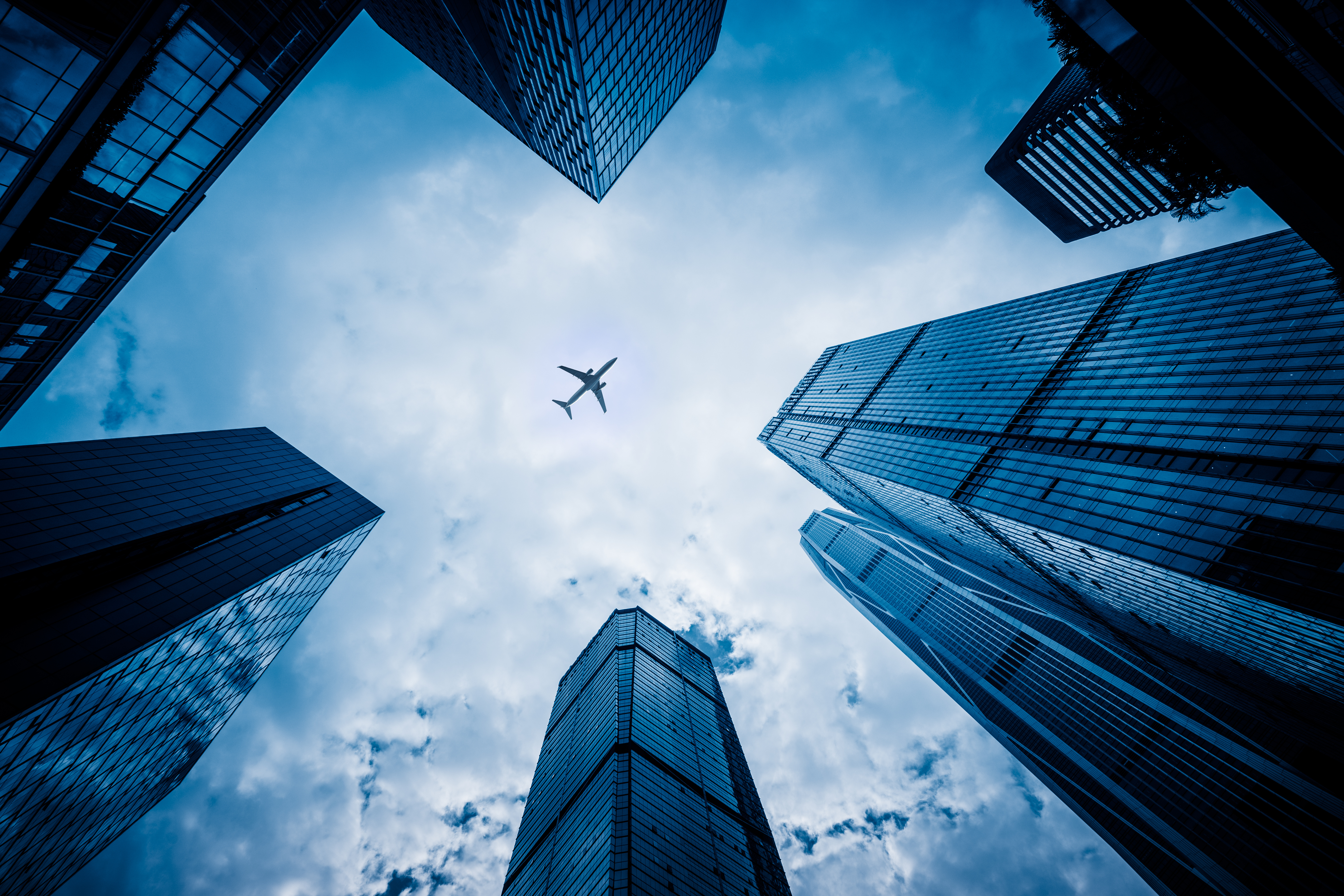 shot of airplane looking up from city street